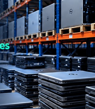 Warehouse shelves with bulk refurbished laptops and desktop PCs
